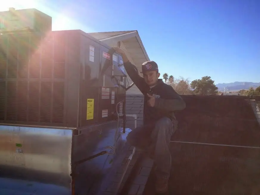 HVAC technician performing AC Tune-Up on a rooftop unit in Lower Swatara